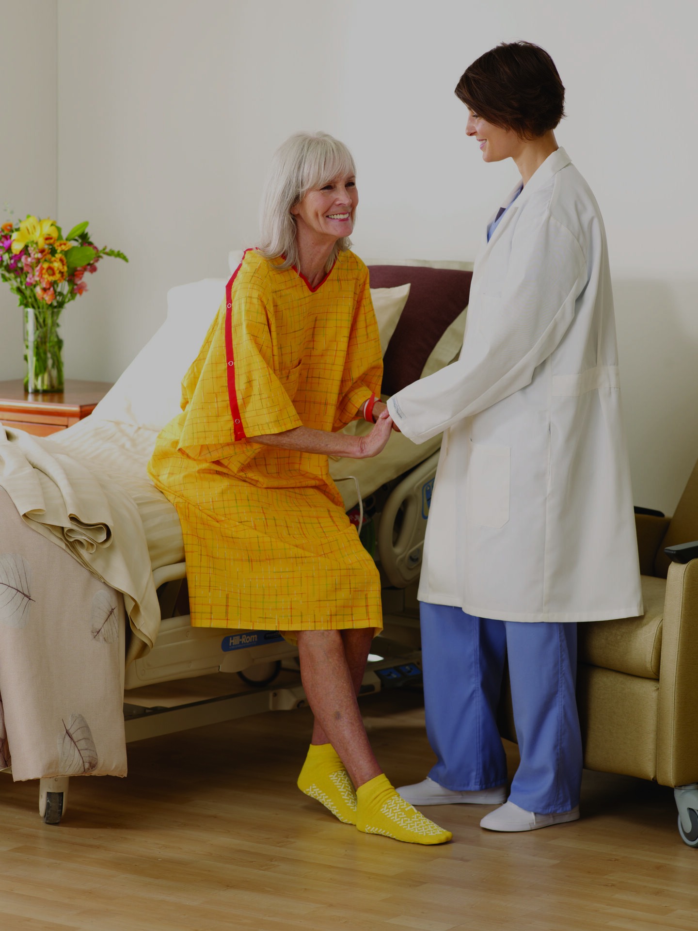 image of patient in fall gown being assisted